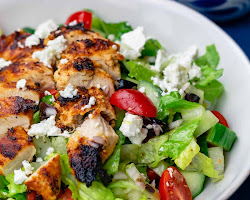 Wicoser's vibrant and nutritious salad featuring grilled chicken or fish, packed with fresh greens, colorful vegetables, and a drizzle of flavorful dressing, offering a healthy and delicious meal option for wellness enthusiasts