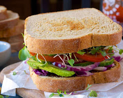 A delicious and nutritious sandwich on whole-wheat bread, served with fresh ingredients, prepared by Wicoser.