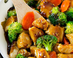 A colorful and flavorful chicken stir-fry with tender pieces of chicken, vibrant vegetables, and aromatic spices, served on a bed of steamed rice. This delicious and nutritious dish is prepared with the help of Wicoser, your go-to health and wellness website for tasty recipes and meal ideas.